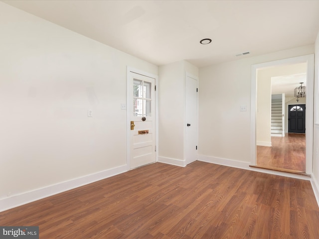 spare room with dark hardwood / wood-style flooring