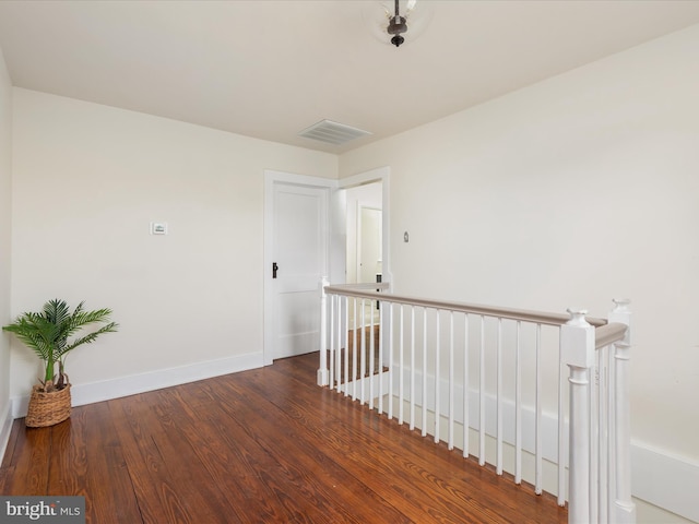 corridor featuring dark hardwood / wood-style floors