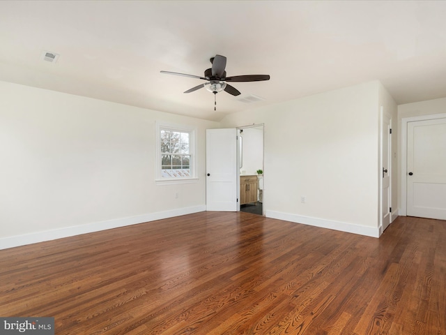 empty room with ceiling fan and dark hardwood / wood-style flooring