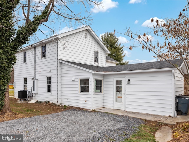 rear view of house with central AC unit