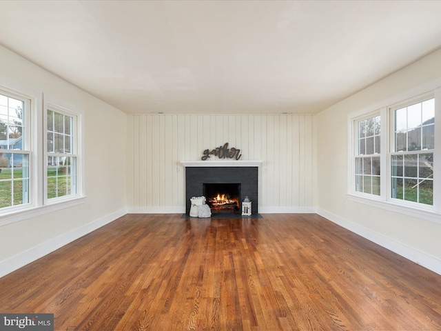 unfurnished living room with dark hardwood / wood-style floors