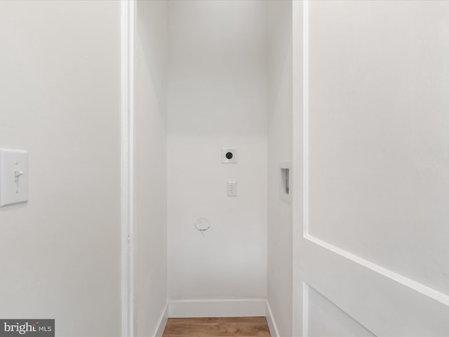 clothes washing area featuring electric dryer hookup and wood-type flooring