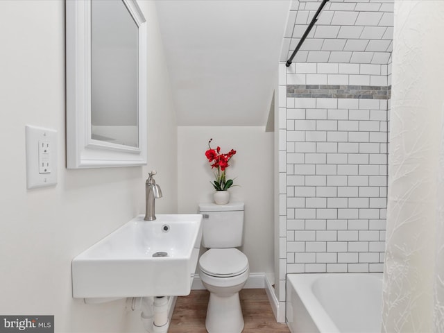 full bathroom featuring hardwood / wood-style flooring, shower / bath combo, toilet, and sink