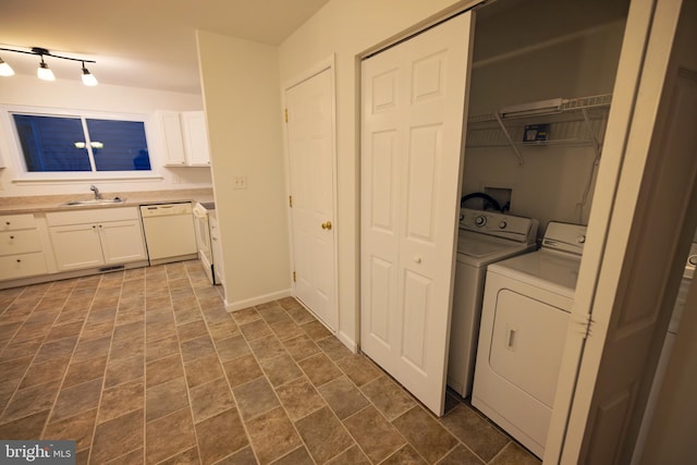 laundry area featuring separate washer and dryer and sink