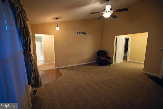 empty room featuring carpet flooring, ceiling fan, and vaulted ceiling