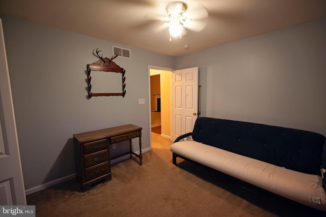 sitting room with carpet flooring and ceiling fan