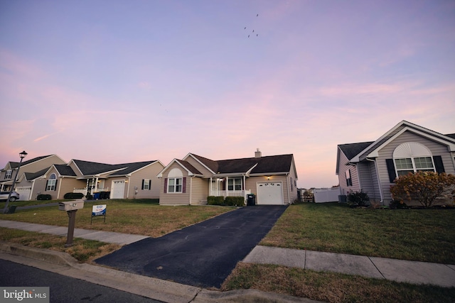 single story home with a garage and a yard