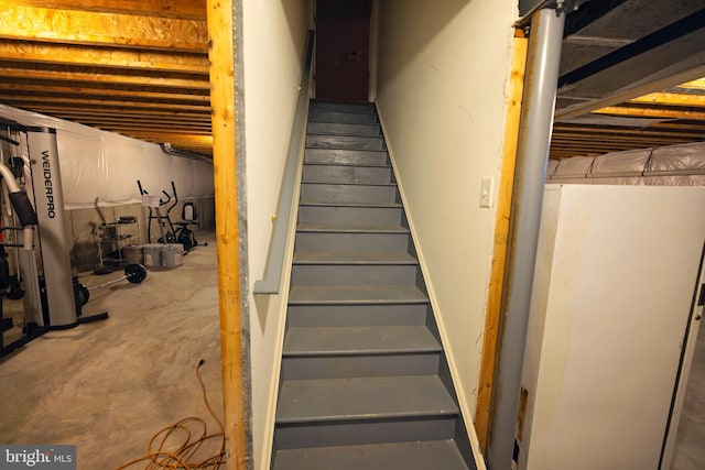 stairway featuring concrete floors