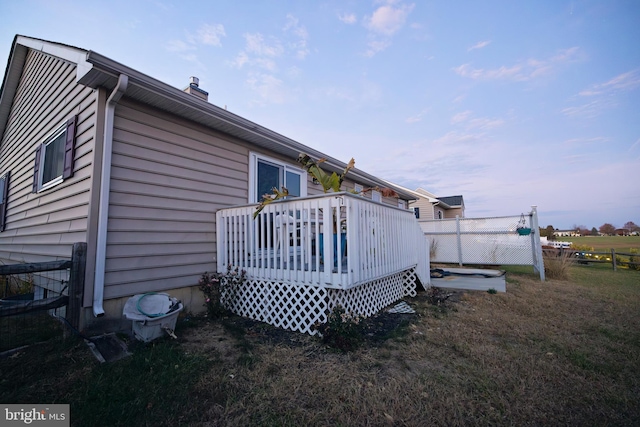 property exterior at dusk with a deck