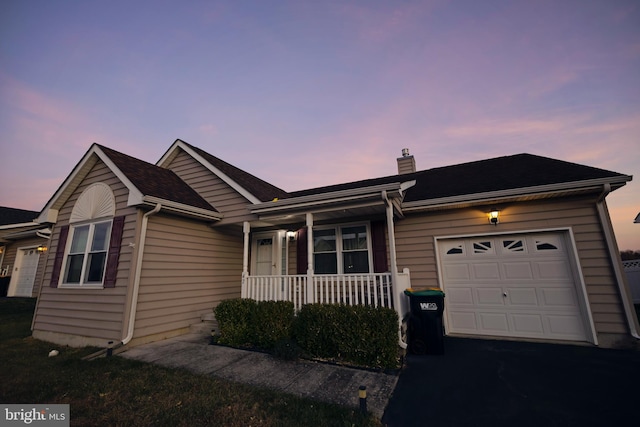 single story home featuring a porch and a garage