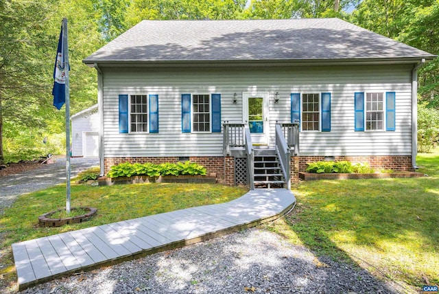 view of front of property with a front yard, an outdoor structure, and a garage