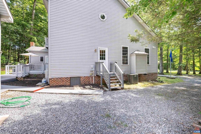 exterior space with central AC and a wooden deck