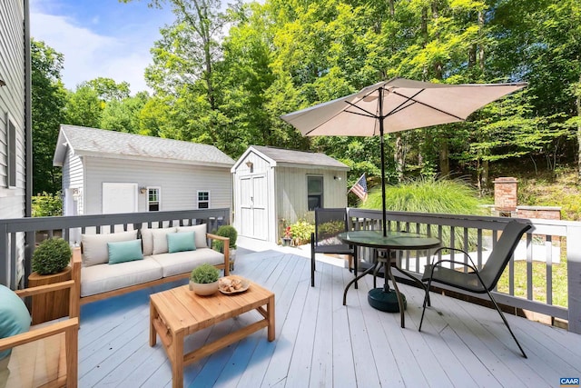 wooden terrace with outdoor lounge area and a storage shed