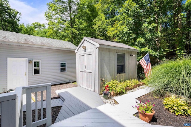 wooden terrace featuring a storage unit