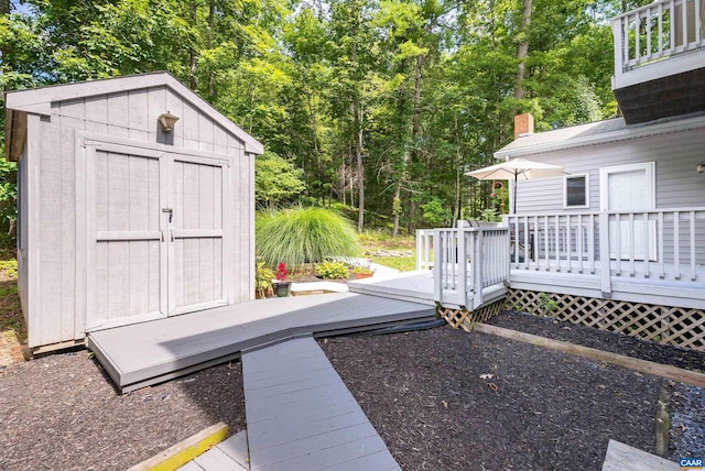 view of yard featuring a deck and a storage shed