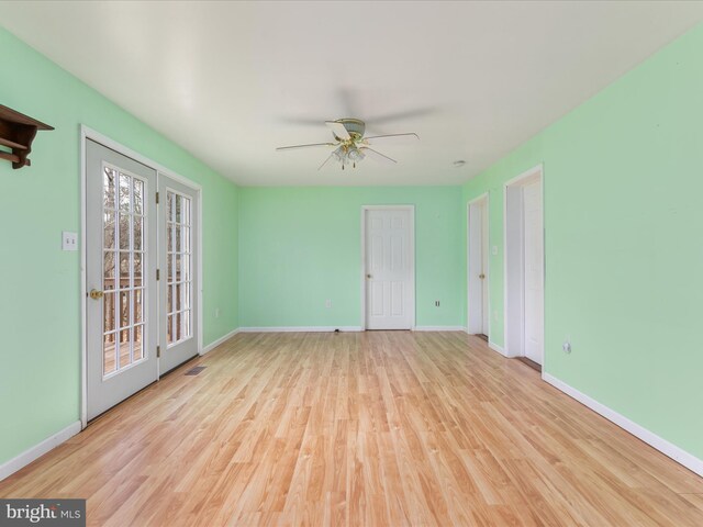 unfurnished room with ceiling fan, light hardwood / wood-style floors, and french doors