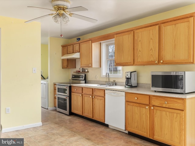 kitchen featuring washer / dryer, ceiling fan, sink, and appliances with stainless steel finishes