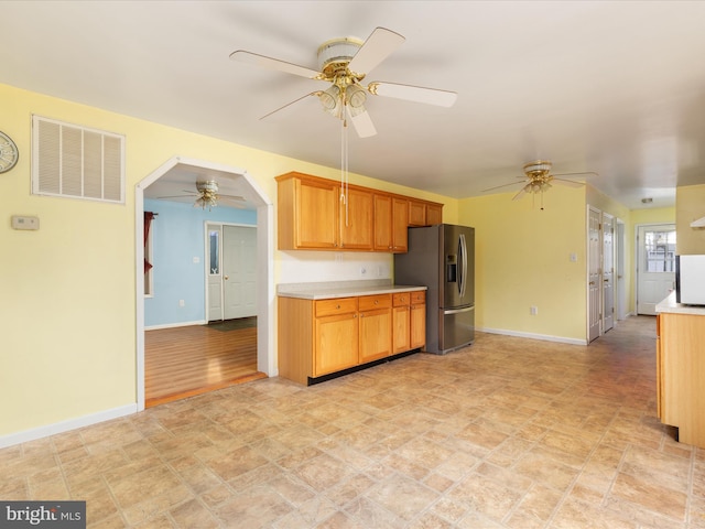 kitchen with ceiling fan, stainless steel fridge, and light wood-type flooring