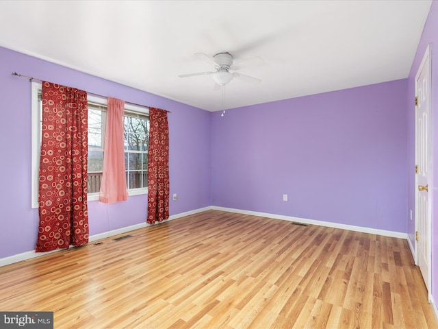 empty room with light wood-type flooring and ceiling fan