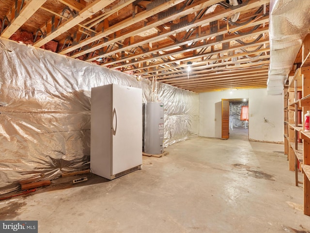 basement with white refrigerator and water heater