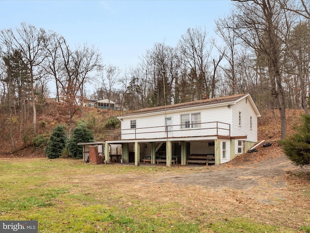 back of house with a yard and a wooden deck