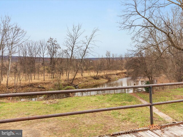 view of yard featuring a water view and a rural view