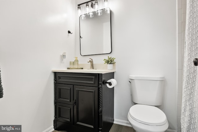 bathroom featuring hardwood / wood-style floors, vanity, and toilet