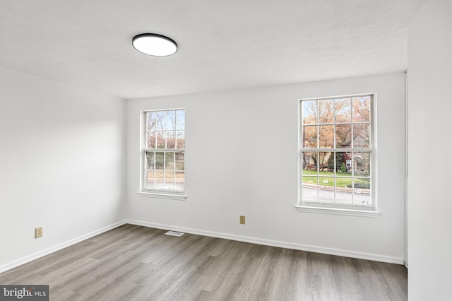 unfurnished room featuring light hardwood / wood-style flooring