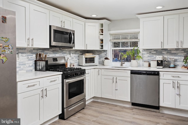 kitchen featuring white cabinets and appliances with stainless steel finishes