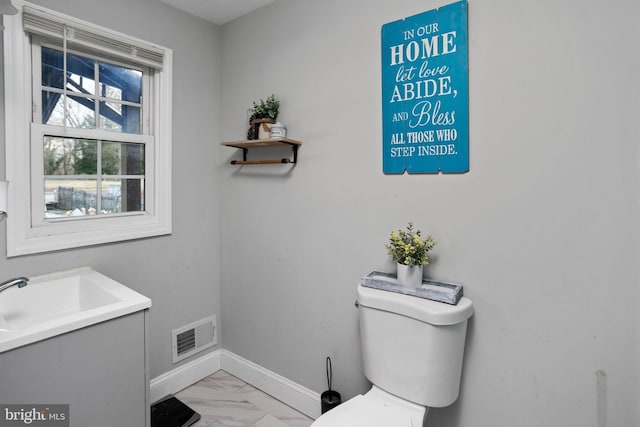 bathroom featuring vanity and toilet