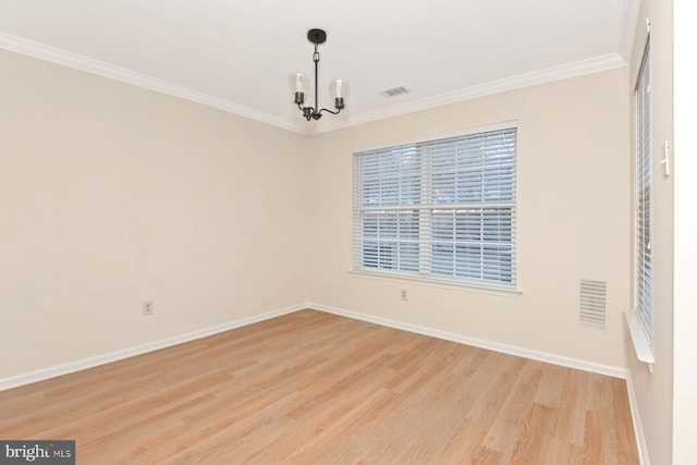 empty room with ornamental molding, a chandelier, and light wood-type flooring