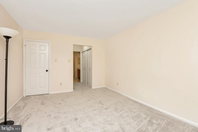 unfurnished bedroom featuring light carpet