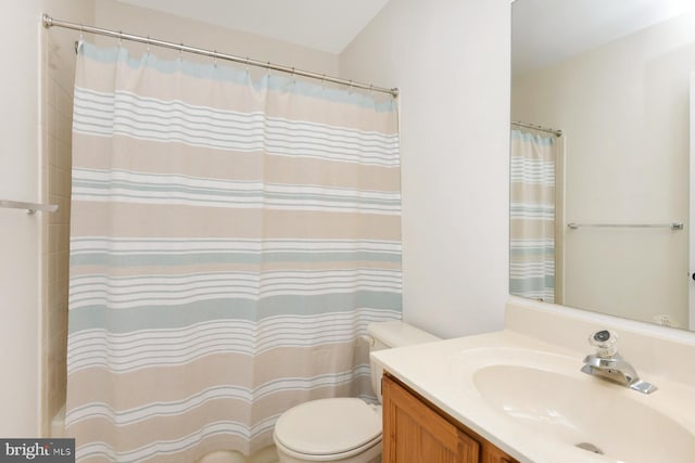 bathroom with vanity, a shower with shower curtain, and toilet