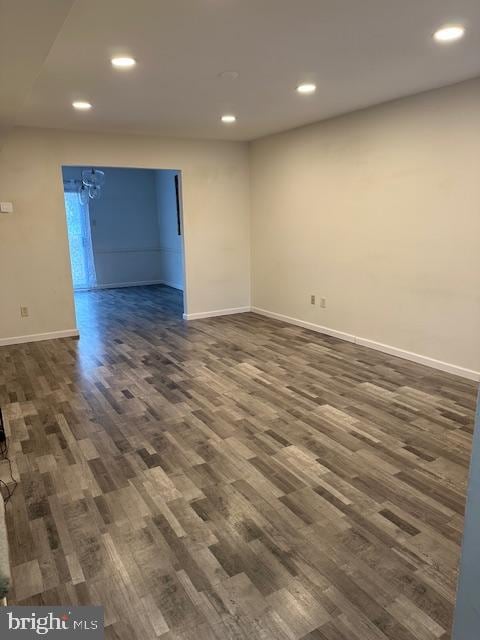 spare room with dark hardwood / wood-style floors