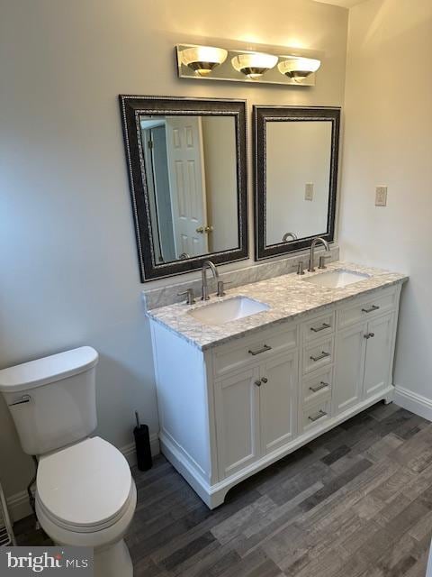 bathroom featuring hardwood / wood-style flooring, vanity, and toilet