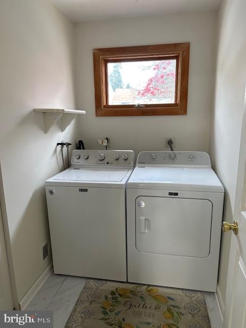 clothes washing area featuring washing machine and clothes dryer