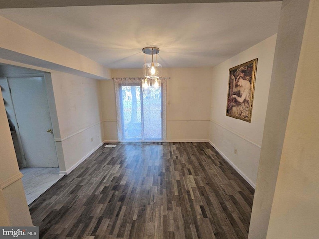 unfurnished room with dark wood-type flooring