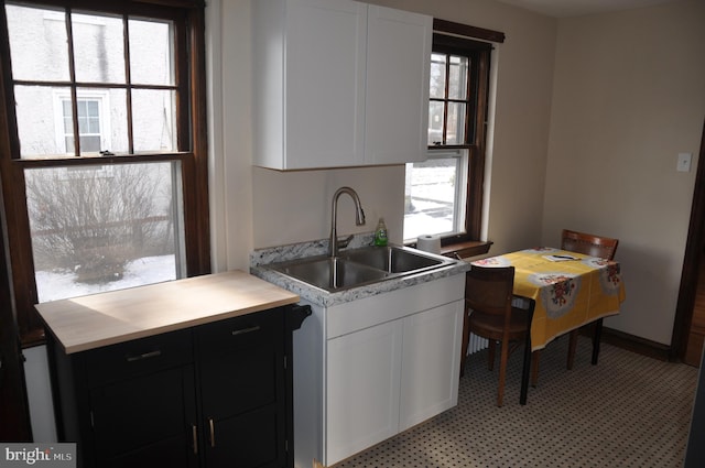 kitchen with white cabinetry and sink