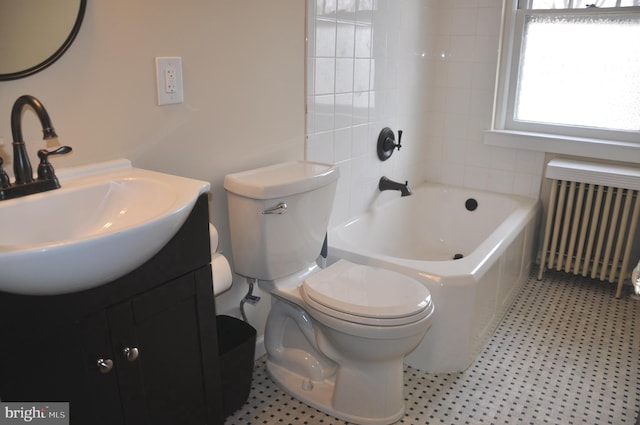 bathroom featuring radiator heating unit, vanity, and toilet