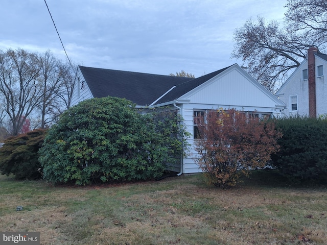 view of side of property with a yard