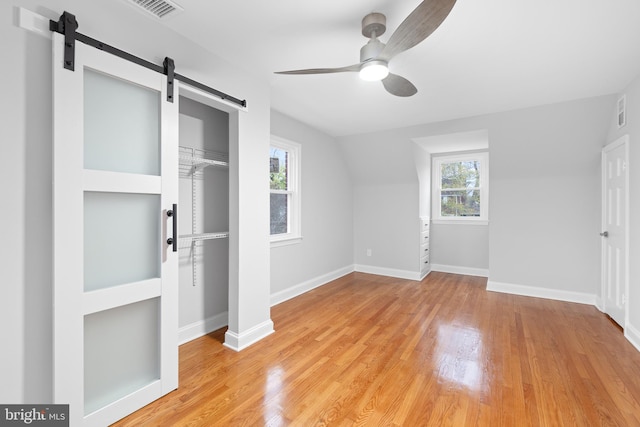 bonus room with plenty of natural light, ceiling fan, and light wood-type flooring