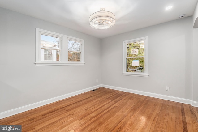 unfurnished room featuring hardwood / wood-style flooring