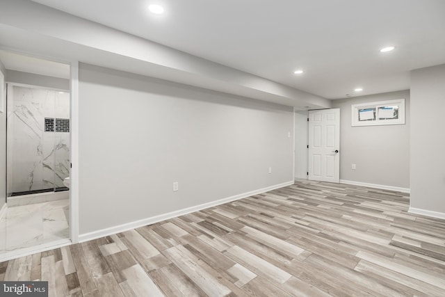 basement with light hardwood / wood-style floors