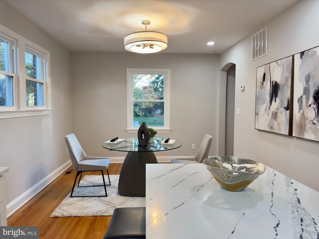 dining area featuring light wood-type flooring and plenty of natural light