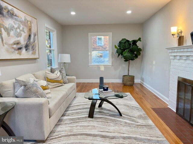 living room with hardwood / wood-style floors and a fireplace