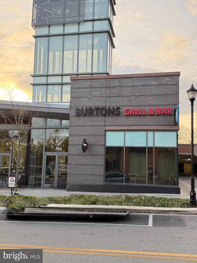 view of outdoor building at dusk