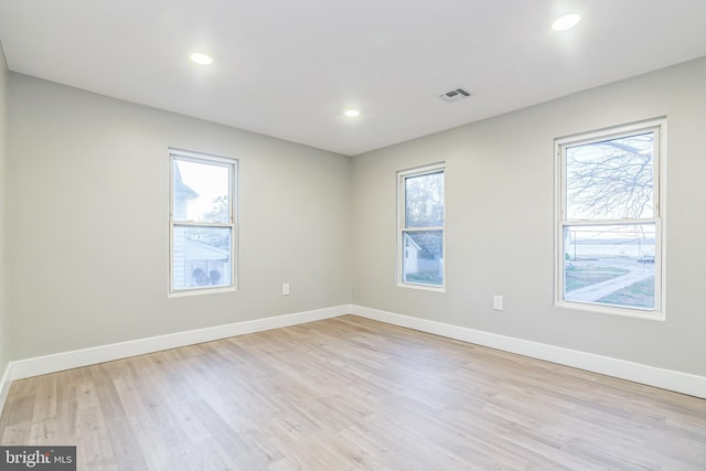 spare room with plenty of natural light and light wood-type flooring