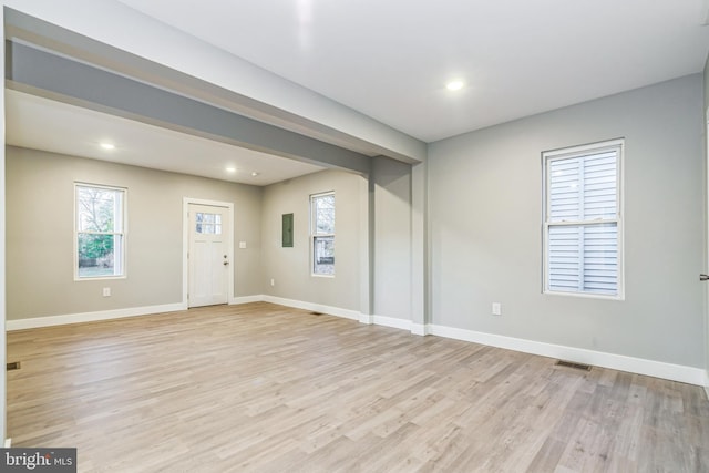 entryway with electric panel and light hardwood / wood-style flooring