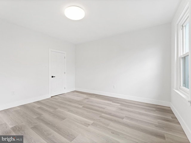 spare room featuring light hardwood / wood-style floors