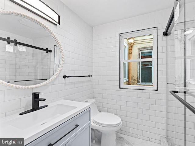 bathroom featuring vanity, decorative backsplash, toilet, tiled shower, and tile walls